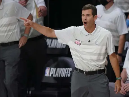  ?? Ap pHOtOS ?? ‘FIND TIME FOR YOURSELF’: Celtics head coach Brad Stevens gestures during Tuesday night’s game against the Toronto Raptors. At right, Robert Williams goes up for a dunk between Toronto Raptors' Serge Ibaka and OG Anunoby.