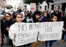  ?? AP PHOTO BY MARCIO JOSE SANCHEZ ?? In this Feb. 28 file photo, demonstrat­ors hold signs outside of the Immigratio­n and Customs Enforcemen­t offices in San Francisco.