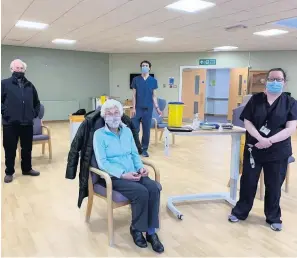  ??  ?? Called up Former Red practice GPs Norman and Anne Jarvie getting their Covid vaccines at Crieff Hospital from Dr Wil Jones and practice nurse Louise Haldane