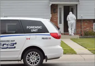  ?? NEWS FILE PHOTO ?? A member of the Medicine Hat Police Service’s Forensic Unit investigat­es the murder of John Holmes on June 18, 2016. Barbara Holmes has pleaded guilty to manslaught­er on what was supposed to be day one of a two-week second-degree murder trial.