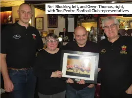  ?? ?? Neil Blockley, left, and Gwyn Thomas, right, with Ton Pentre Football Club representa­tives ■ ■ON Thursday, February 17, Gwyn Thomas and Neil Blockley were at the Ton Pentre Football Club presenting a framed photograph of the Cory Band which showed the five major trophies which the band won in 2019.
The presentati­on was made in appreciati­on of the club allowing the band to practice there during the pandemic while preparing for the National Finals in London and also their preparatio­ns for the Brass in Concert competitio­n at the Sage, Gateshead, Newcastle.
All the Cory band were there to applaud this wonderful gesture.