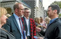  ?? PHOTO: STACY SQUIRES/STUFF ?? Christchur­ch landlord David Townshend hands a petition to Parliament asking the Governemnt to look into why Christchur­ch earthquake repairs were failing over to then Labour leader Andrew Little and future Christchur­ch Regenerati­on minister Megan Woods...