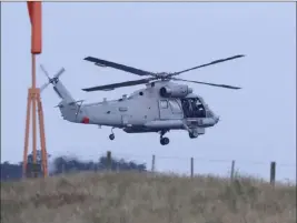  ?? Mark Baker The Associated Press ?? A New Zealand navy helicopter takes off from Whakatane Airport as the mission to find the bodies of victims of the White Island eruption gets underway early Friday.