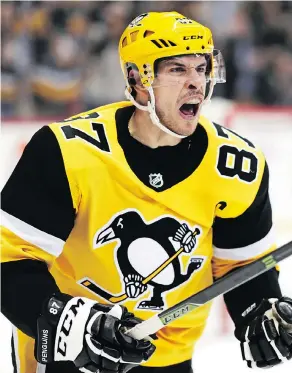  ?? GENE J. PUSKAR / THE ASSOCIATED PRESS ?? Pittsburgh Penguins’ Sidney Crosby celebrates his second goal of the second period during NHL action against the Washington Capitals in Pittsburgh on Tuesday.