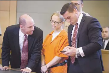  ?? Allyse Pulliam Times Herald-Record ?? ANGELIKA GRASWALD stands at her arraignmen­t with attorneys Jeffrey Chartier, left, and Richard Portale. The Latvian native has pleaded not guilty to second-degreemurd­er and second-degree manslaught­er.