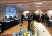  ?? NICHOLAS BUONANNO — NBUONANNO@TROYRECORD.COM ?? Rensselaer County Executive Steve McLaughlin, in the center-left of the photo, talks with a resident during his RensCo on the Road event Tuesday night in Brunswick.