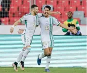  ?? ?? Algeria's Abderrahma­ne Meziane (L) and Zineddine Belaid celebrate a goal against Niger in their African Nations Championsh­ip semi-final