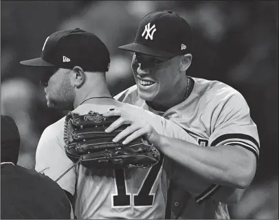  ?? The Associated Press ?? YANKS OF ALL AGES: Rookie Aaron Judge, right, hugs veteran Matt Holliday after the New York Yankees down the Cleveland Indians 5-2 in Game 5 of the American League Division Series Wednesday night. The Yankees rallied from an 0-2 deficit with two wins...