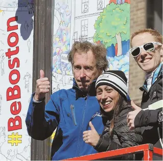  ?? STAFF PHOTOS BY ANGELA ROWLINGS ?? ALL THE WAY: Boston Marathon legend Bill Rodgers, left, and Olympic marathon runners Desiree Linden and Eric Gillis pose with new Boston Marathon banners on a streetligh­t on Boylston Street yesterday.