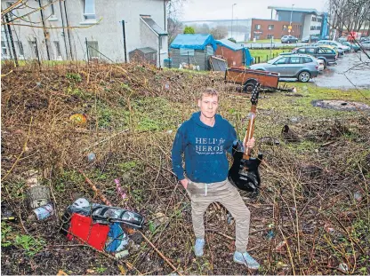  ??  ?? Rubbish spilling into Harry Marshall’s garden has included tyres, TVs and even an electric guitar.