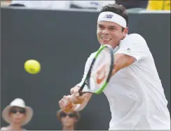  ?? The Associated Press ?? Canada’s Milos Raonic returns the ball to Russia’s Mikhail Youzhny during their men’s singles match at the Wimbledon Tennis Championsh­ips in London on Thursday. Raonic won 3-6, 7-6 (7), 6-4, 7-5.