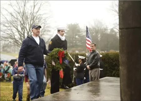  ?? LAUREN A. LITTLE — MEDIANEWS GROUP ?? Retired Third Class Petty Officer Thomas Fick, left, and Navy Sea Cadet Salvatore Machine hang the Navy wreath Dec. 14on a monument at Forest Hills Memorial Park as part of the national Wreaths Across America program.