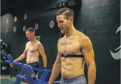  ??  ?? OPP officer John Witzing, left, and personal trainer Josh Chessman train for their planned 24-hour run in a darkened storage container, where they hope to see how far they can run in total darkness and seclusion.