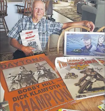 ?? [TIM MAY/DISPATCH] ?? Dick Klamfoth poses with memorabili­a collected over his long career in motorcycle racing. The 88-year-old is part of the 2017 class being inducted into the Motorsport­s Hall of Fame of America.