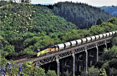  ??  ?? RIGHT: This magnificen­t view of the Cornish main
line, albeit single track at this point, was taken on May 15, 2019 with Colas Class 70 70802 crossing the impressive St Pinnock Viaduct between Liskeard and Bodmin Parkway
while powering the 0250 Aberthaw Cement Works to Moorswater. The train was booked to travel to Lostwithie­l to run round, but on this occasion it ran round at Liskeard.
