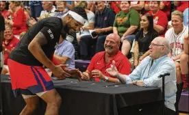  ?? DAVID JABLONSKI/STAFF ?? Devin Oliver of the Red Scare greets WHIO Radio’s Larry Hansgen and Bucky Bockhorn before the first-round game in The Basketball Tournament on Friday at Capital University in Bexley. Oliver played in Turkey and Germany last season.