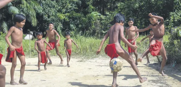  ??  ?? Waiapi boys play football in the Manilha village.
