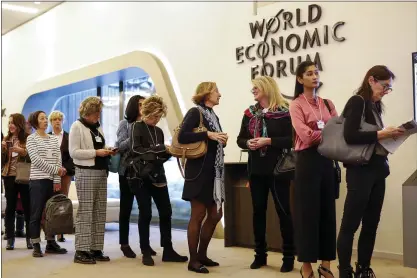  ?? JASON ALDEN — STAFF PHOTOGRAPH­ER ?? Female attendees line up for a panel session at the World Economic Forum in Davos, Switzerlan­d, last month. According to new research, a woman’s income was needed to help the household meet the threshold for the top 1 percent only 15 percent of the time.