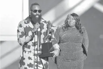  ?? ASSOCIATED PRESS ?? NBA player James Harden, of the Houston Rockets, left, accepts the most valuable player award as his mother, Monja Willis, looks on at the NBA Awards at the Barker Hangar in Santa Monica, Calif.