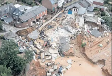  ?? SEBASTIAN BOZON — AFP VIA GETTY IMAGES ?? An aerial view shows an area destroyed by the floods in Erftstadt, southwest of Cologne, Germany, on Friday. The death toll from devastatin­g floods in Europe soared to more than 125 on Friday, most in western Germany.