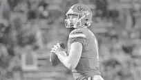  ?? EBENHACK|AP PHELANM ?? Florida quarterbac­kKyleTrask surveys the field during his six-touchdown night for the Gators during their 63-35 win against Arkansas.