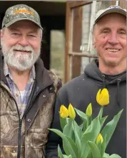  ?? Photo by Janet Bard ?? In the snapshot, Tom Pierotti and Bob Barron share a moment while holding bright yellow tulips, adding a touch of springtime cheer to their surroundin­gs.