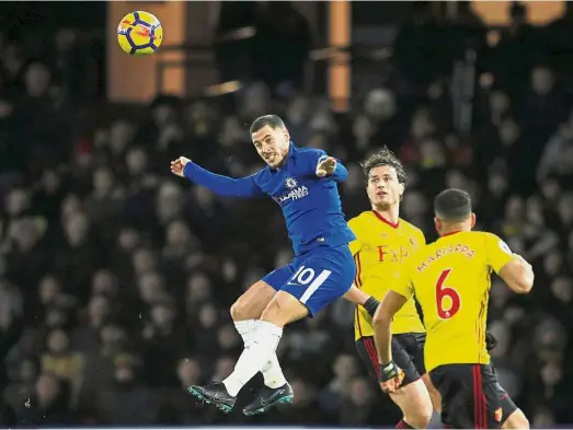  ?? — Reuters ?? For a greater purpose: Chelsea’s Eden Hazard heading the ball in the Premier League match against Watford at Vicarage Road on Monday.