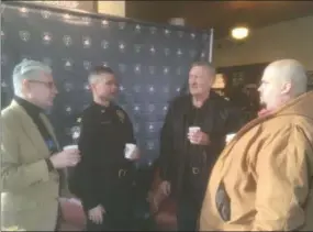  ?? ZACHARY SRNIS — THE MORNING JOURNAL ?? Jeffrey Phail, Avon police chaplain, left, Avon police Capt. Larry Fischbach, Elvis Dollar, a member of Christian Heritage Church in Avon, and Ryan Workman, children’s pastor at Christian Heritage Church, talk over coffee at Avon Starbucks on Detroit Road.