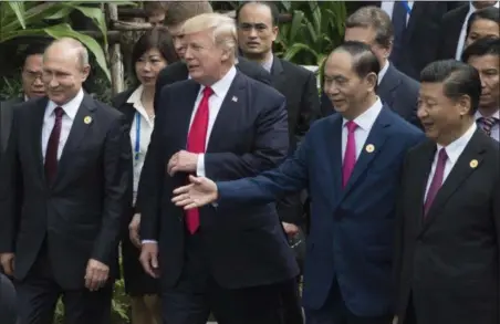 ?? ADRIAN WYLD — THE CANADIAN PRESS VIA AP ?? Left to right; Russian President Vladimir Putin, U.S. President Donald Trump, Vietnamese President Tran Dai Quang and Chinese President Xi Jinping walk to the group photo at the APEC Summit in Danang, Vietnam, Saturday.