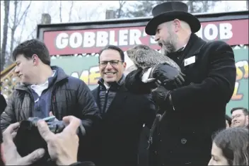  ?? PHOTO COURTESY OF LARRY MCGUIRE ?? Punxsutawn­ey Phil takes a photo with Pennsylvan­ia Governor Joshua David Shapiro (center) during the annual Groundhog Day ceremony, February 2, in Punxsutawn­ey, Pennsylvan­ia.