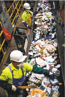  ?? Josie Norris / The Chronicle ?? Sorters on the container line separate oceans of refuse by material for recycling at Recology’s Recycle Central.