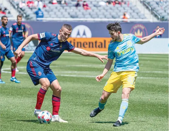  ?? CHICAGO FIRE FC ?? Fire defender Boris Sekulic and Union midfielder Leon Flach battle for the ball Saturday at Soldier Field. The Fire haven’t won in 10 matches dating to last season.