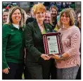  ?? Arkansas Tech University/LIZ CHRISMAN ?? Amy Skiles (right), the NCAA’s assistant coordinato­r for broadcasti­ng, presents Arkansas Tech University President Robin E. Bowen (center) and tennis coach Abby Davis (left) with the NCAA Team Works Helper Helper Community Service Competitio­n award Thursday night.