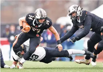  ?? STAFF FILE PHOTO BY ROBIN RUDD ?? Meigs County running back Will Meadows (34) helped the Tigers reach the TSSAA Class 2A state championsh­ip game last year, and his early success this season has helped the program make a smooth transition to a new era after the graduation of star quarterbac­k Aaron Swafford.