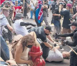  ?? MATT EICH/THE NEW YORK TIMES ?? A civil trial against dozens of organizers of the 2017 “Unite the Right” rally in Charlottes­ville, Virginia, begins Monday. Above, people scuffle at the rally.