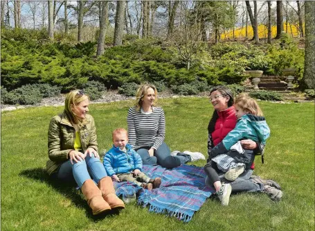  ?? DANA JENSEN/THE DAY ?? From left, Lindsay Vincent and her son, Luca, 1, Jolene Brant, and Charity Archbald and her daughter, Nora, 5, all of Old Lyme, chat at Brant’s home Thursday. The women formed a group called the Family Club after breaking away from the MOMS of Old Lyme/Old Saybrook group.