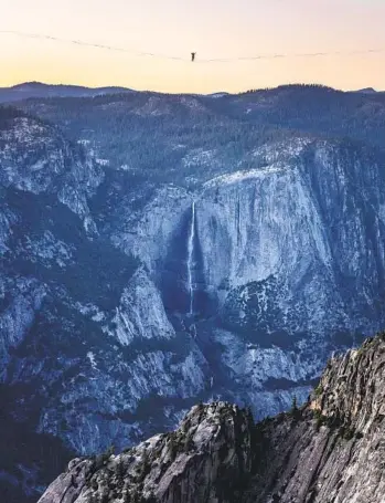  ?? SCOTT OLLER FILMS VIA AP ?? Daniel Monterrubi­o walks a 2,800-foot-long slackline off Taft Point above Yosemite Valley on June 12. The longest line walked in Yosemite previously had been a 954-footer.