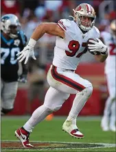  ??  ?? 49ers defensive end Nick Bosa runs after making an intercepti­on against the Carolina Panthers at Levi’s Stadium. The rookie sensation also had three sacks.