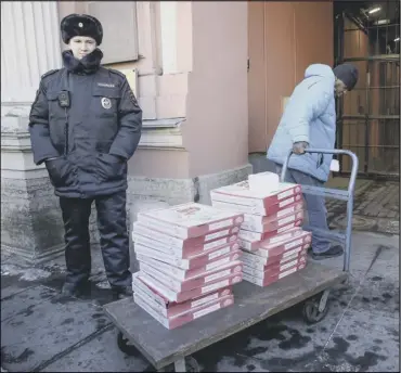  ??  ?? A US consulate worker pulls a trolley carrying a pizza delivery into the consulate in St Petersburg