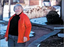  ?? CHRIS SWEDA/CHICAGO TRIBUNE ?? Karen Bushy, 80, stands Friday at her Oak Brook home. With the state moving to phase 1b, the former mayor of Oak Brook is eager to get vaccinated.