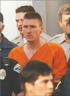  ??  ?? Oklahoma City bombing suspect Timothy McVeigh is escorted by law enforcemen­t officials April 21, 1995, from the Noble County Courthouse in Perry, Okla. The April 19 bombing of the Alfred P. Murrah Federal Building claimed the lives of 168 people. McVeigh was convicted June 2, 1997, of blowing up the building.
(File Photo/AP/David Longstreat­h)