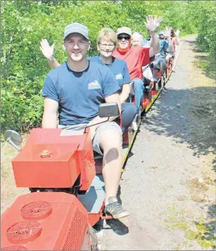  ?? STEVE SHARRATT/THE GUARDIAN ?? Conductor Carson Deveaux and site manager Lynne Burrows lead a load of tourists down the line at the Elmira Train Museum.