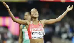  ??  ?? LONDON: Kenya’s Faith Chepngetic­h Kipyegon, front, celebrates as she wins the gold medal in the final of the Women’s 1500m during the World Athletics Championsh­ips in London Monday. South Africa’s Caster Semenya, bronze, is in the rear. — AP