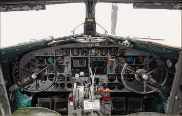  ?? Photos by Paul Buckowski /Times Union ?? A view of the cockpit inside the Placid Lassie, a C-47 that flew in D-Day, is seen at The Hangar at 743 in Colonie. The bottom left photo shows a view of a Ford GPW Willys military jeep. At bottom right is pieces of Old Glory, a B-25 airplane that suffered a crash.