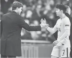 ??  ?? Tottenham Hotspur’s Argentinia­n head coach Mauricio Pochettino shakes hands with Son Heung-Min as he leaves the pitch. — AFP photo