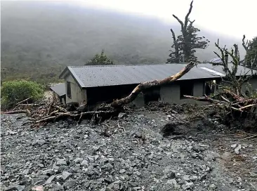  ?? STUFF ?? The Lake Howden Hut was surrounded by green foliage before a landslide with trees, mud and rocks slammed into it during a storm in February.