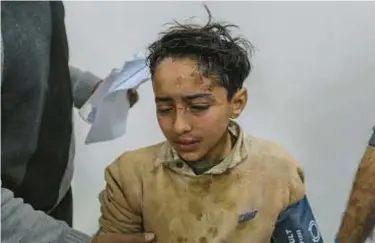  ?? GETTY ?? A Palestinia­n child injured in Israeli air strikes arrives at a hospital for treatment in Rafah, Gaza.