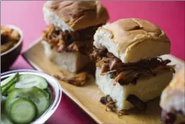  ??  ?? Shredded pork sliders, above, with gochujang barbecue sauce, and chili-braised beef short ribs made using an electric pressure cooker.