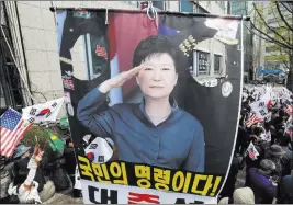  ?? Ahn Young-joon ?? The Associated Press Supporters of former South Korean President Park Geun-hye with her portrait stage a rally to call for her release near the Seoul Central District Court on Friday.