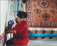  ?? LI LEI / CHINA DAILY ?? A woman weaves a carpet by hand at a local workshop in the Xinjiang Uygur autonomous region in May.